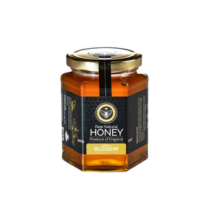 Jar of raw blossom honey with a More Bees Please label